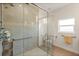 Accessible shower area with glass enclosure, tiled walls, and handrails at 240 Spring Forest Dr, New Smyrna Beach, FL 32168