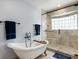 Luxurious bathroom featuring a soaking tub and a separate glass-enclosed shower at 240 Spring Forest Dr, New Smyrna Beach, FL 32168