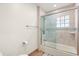 Bathroom featuring a tiled shower and tub, tile walls, and wood-look flooring at 240 Spring Forest Dr, New Smyrna Beach, FL 32168