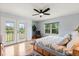 Comfortable bedroom features a ceiling fan, natural light, and access to a private balcony at 240 Spring Forest Dr, New Smyrna Beach, FL 32168