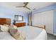 Calming bedroom with ceiling fan, closet, wooden bed and dresser, and light blue walls at 240 Spring Forest Dr, New Smyrna Beach, FL 32168