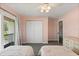Comfortable pink bedroom showcases closet, balcony access and carpeted flooring at 240 Spring Forest Dr, New Smyrna Beach, FL 32168