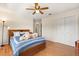 Bright bedroom features a ceiling fan, closet, and wood-look floors at 240 Spring Forest Dr, New Smyrna Beach, FL 32168