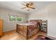 Comfortable bedroom with a large window and hardwood floors at 240 Spring Forest Dr, New Smyrna Beach, FL 32168
