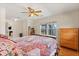 Bedroom featuring a ceiling fan, a large window, and wood flooring at 240 Spring Forest Dr, New Smyrna Beach, FL 32168