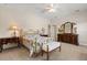 Bright bedroom with carpet flooring, a ceiling fan, and dark wood furnishings at 240 Spring Forest Dr, New Smyrna Beach, FL 32168