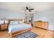 Bright bedroom featuring hardwood floors, comfortable bed and access to other rooms at 240 Spring Forest Dr, New Smyrna Beach, FL 32168