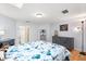 Cozy bedroom featuring a storage dresser, shelving, and hardwood flooring at 240 Spring Forest Dr, New Smyrna Beach, FL 32168