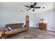 The bonus room features beautiful flooring, a ceiling fan, and comfortable seating at 240 Spring Forest Dr, New Smyrna Beach, FL 32168