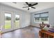 Bright, airy bonus room with an exterior door and windows offering views of the lush outdoors at 240 Spring Forest Dr, New Smyrna Beach, FL 32168
