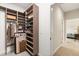 Walk-in closet featuring wood-look organizers for folded clothes and hanging storage at 240 Spring Forest Dr, New Smyrna Beach, FL 32168