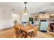 Bright dining area featuring a wooden table, chairs, and a decorative hanging lamp at 240 Spring Forest Dr, New Smyrna Beach, FL 32168