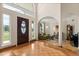 Bright foyer with high ceilings, arched doorways, and a decorative wood front door with glass insert at 240 Spring Forest Dr, New Smyrna Beach, FL 32168