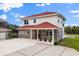Beautiful two-story home featuring brick accents, red roof, and manicured landscaping at 240 Spring Forest Dr, New Smyrna Beach, FL 32168