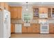 Well-lit kitchen featuring stainless-steel appliances, a farmhouse sink, and light wood cabinetry at 240 Spring Forest Dr, New Smyrna Beach, FL 32168