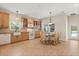 Well-lit kitchen and dining area featuring wood-look tile flooring and light wood cabinetry at 240 Spring Forest Dr, New Smyrna Beach, FL 32168