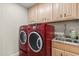Convenient laundry room featuring a red washer and dryer and granite countertop at 240 Spring Forest Dr, New Smyrna Beach, FL 32168