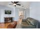 Cozy living room featuring hardwood floors, a comfortable couch, and an open doorway to the stairwell at 240 Spring Forest Dr, New Smyrna Beach, FL 32168