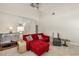 Bright living room with soaring ceilings, a red sofa and an upper level view at 240 Spring Forest Dr, New Smyrna Beach, FL 32168