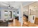 Bright living area with hardwood floors, balcony access, and an open doorway to the game room at 240 Spring Forest Dr, New Smyrna Beach, FL 32168