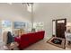 Bright living room features a red sofa and a soaring ceiling at 240 Spring Forest Dr, New Smyrna Beach, FL 32168