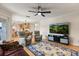 Open-concept living room with a ceiling fan and view of kitchen and dining areas at 240 Spring Forest Dr, New Smyrna Beach, FL 32168