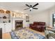 Cozy living room showcases a fireplace with custom built-ins and a plush leather couch at 240 Spring Forest Dr, New Smyrna Beach, FL 32168