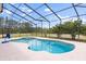 Inviting screened pool with spa and tranquil views of the surrounding lush greenery at 240 Spring Forest Dr, New Smyrna Beach, FL 32168