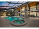 Stunning screened pool and spa area with brick pillars, and an outdoor dining area at 240 Spring Forest Dr, New Smyrna Beach, FL 32168