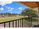 Scenic view from the balcony overlooking the green field, water and the white fence at 240 Spring Forest Dr, New Smyrna Beach, FL 32168