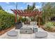 Cozy backyard patio with pergola, comfortable seating, and outdoor grill area at 2602 Winter Park Rd, Winter Park, FL 32789