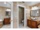Bright bathroom with dual sinks, granite countertops, tile walls, and toilet room at 2602 Winter Park Rd, Winter Park, FL 32789