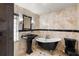 Stylish bathroom featuring a classic clawfoot tub, pedestal sink, and black tile accents at 2602 Winter Park Rd, Winter Park, FL 32789