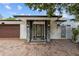 Inviting front entrance featuring modern stonework, elegant lighting, and a stylish glass door at 2602 Winter Park Rd, Winter Park, FL 32789