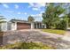 Charming single-story home with an expansive brick driveway and manicured landscaping at 2602 Winter Park Rd, Winter Park, FL 32789