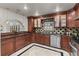 Elegant kitchen featuring dark granite countertops and custom wood cabinetry at 2602 Winter Park Rd, Winter Park, FL 32789