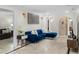 Comfortable living room with travertine floors, modern lighting, and a stylish blue sofa at 2602 Winter Park Rd, Winter Park, FL 32789