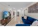 Inviting living room with a stylish blue sofa and view to hallway at 2602 Winter Park Rd, Winter Park, FL 32789