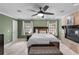 Comfortable main bedroom with a stone fireplace, ceiling fan and bright natural lighting at 2602 Winter Park Rd, Winter Park, FL 32789