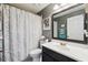 Bathroom featuring a patterned shower curtain, mirror, and toilet at 2611 Burwood Ave, Orlando, FL 32837