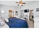 Bright bedroom with a ceiling fan, decorative wall art, and ensuite bathroom at 2611 Burwood Ave, Orlando, FL 32837