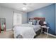 Inviting bedroom featuring a comfortable bed with plush pillows and a bedside table with lamp at 2611 Burwood Ave, Orlando, FL 32837