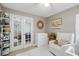 Cozy Bedroom with white furniture, plush rug, and ample natural light. Features a charming decor at 2611 Burwood Ave, Orlando, FL 32837