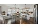 Bright kitchen and dining area featuring pendant lighting, a center island, and dark wood flooring at 2611 Burwood Ave, Orlando, FL 32837