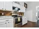 Well-equipped kitchen with stainless steel appliances, white cabinets, and butcher block countertops at 2611 Burwood Ave, Orlando, FL 32837