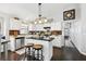 Open-concept kitchen with a center island, white cabinetry, and a wood paneled wall at 2611 Burwood Ave, Orlando, FL 32837