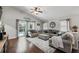 Living room with neutral tones and cozy seating; the sliding glass doors offer views of the outdoor pool at 2611 Burwood Ave, Orlando, FL 32837