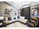 Cozy living room featuring a large sectional sofa, dark curtains, and movie-themed decor at 2611 Burwood Ave, Orlando, FL 32837