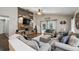 Spacious living room featuring a decorative wood accent wall, neutral tones, and ample seating at 2611 Burwood Ave, Orlando, FL 32837