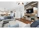 Cozy living room with open floor plan, hardwood flooring, and decorative wood accent wall at 2611 Burwood Ave, Orlando, FL 32837